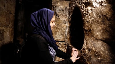 A tourist prays in the Church of the Nativity in Bethlehem, in the occupied West Bank, December 10, 2018. Reuters