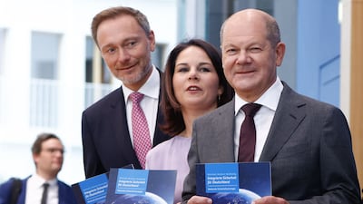 German Chancellor Olaf Scholz, right, and senior cabinet ministers present the country's first national security report in Berlin. AFP