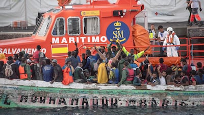 A Spanish search and rescue boat escorts a fishing vessel with 174 migrants on board into La Restinga port on El Hierro, one of Spain's Canary Islands. AFP