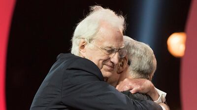 Tavernier embraces Keitel as he receives a career tribute award. EPA