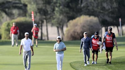 Tommy Fleetwood, Dustin Johnson, left, and Rory McIlroy, right.