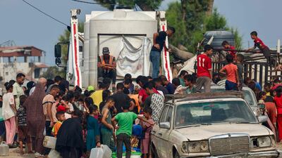 Palestinians queue for water in Gaza. AFP