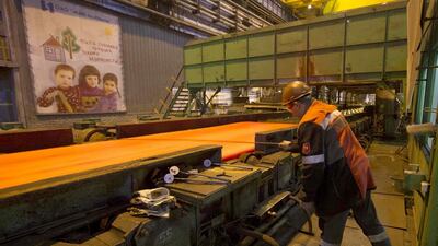 A steelworker makes measurements of a steel billet at the Ilich iron and steel plant. Other Metinvest plants in the Donbas region have been shut because of the conflict. Vasily Fedosenko / Reuters