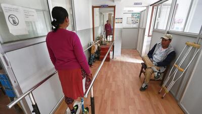 Dan Maya Maharjan, looks in a mirror in the Orthopedic rehabilitation center in Kathmandu, Nepal. Narendra Shrestha / EPA