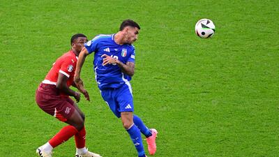 Italy's midfielder Lorenzo Pellegrini heads the ball. AFP