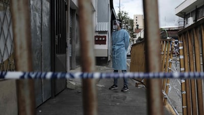 Police officers and personnel of the ministry of health inspect a room rental centre where a person died after contracting Covid-19, in San Jose, Costa Rica. EPA