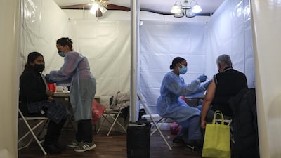 Healthcare workers administer Pfizer-BioNTech Covid-19 vaccines at a vaccination site inside a church in the Bronx borough of New York, US. Bloomberg