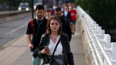 Commuters cross Waterloo Bridge in London. The British Retail Consortium said spending in store chains rose by 6.9 per cent in annual terms in December, but this was a long way off consumer price inflation, which hit 10.7 per cent in November. Reuters
