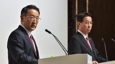 Toyota Motor president Akio Toyoda (L) answers questions as Mazda Motor president and chief executive Masamichi Kogai (R) looks on during their joint press conference at a hotel in Tokyo on August 4, 2017. Kazuhiro Nogi / Agence France-Presse