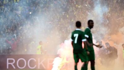 Saudi Arabia players look on after Malaysian fans set off smoke bombs and rockets during the 88th minute of the 2018 World Cup and 2019 Asian Cup qualifier at the Shah Alam Stadium on September 8, 2015 in Kuala Lumpur, Malaysia. Stanley Chou / Getty Images