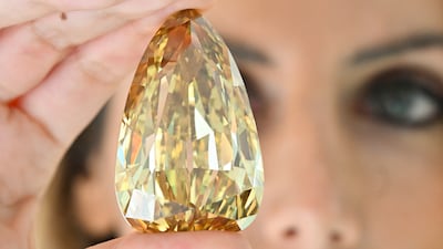 Katia Nounou Boueiz, head of Sotheby’s UAE, with the Golden Canary diamond. At 303.10 carats, it is one of the largest polished diamonds in the world. Photo: Sotheby's Dubai