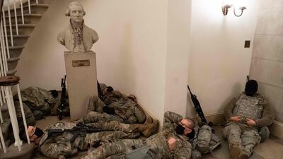 Members of the National Guard take a rest in the Rotunda of the US Capitol in Washington, DC. AFP