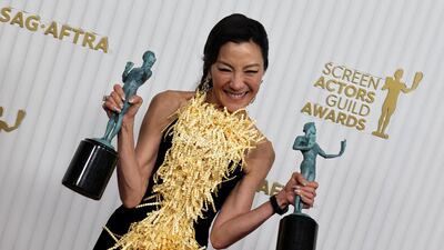 Michelle Yeoh with her best actress and best ensemble awards for Everything Everywhere All at Once. Reuters