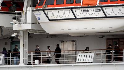 Passengers walk on a deck of the Diamond Princess. EPA
