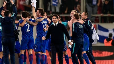 Croatia's coach Zlatko Dalic, centre, celebrates qualification for the 2018 World Cup with his players. Angelos Tzortziniz / AFP