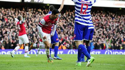 Mikel Arteta celebrates scoring for Arsenal against QPR. Glyn Kirk/AFP