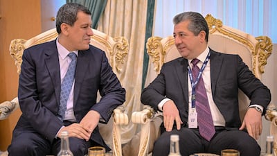 Mazloum Abdi, left, leader of the Kurdish-led Syrian Democratic Forces, speaks to Prime Minister Masrour Barzani of the Iraqi Kurdistan Regional Government, at the Middle East Peace and Security Forum in Duhok. Kurdistan Regional Government / AFP