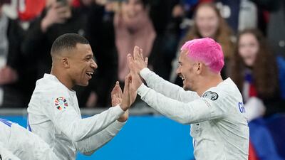 France's Antoine Griezmann, right, celebrates with Kylian Mbappe after scoring his side's opening goal during the Euro 2024 qualifier against Netherlands at the Stade de France on Friday, March 24, 2023. AP