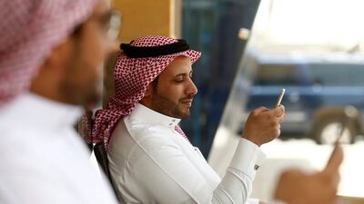 Saudi men explore social media on their mobile devices as they sit at a cafe in Riyadh. Faisal Al Nasser / Reuters