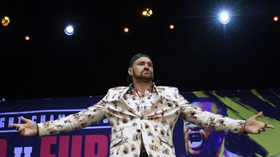 Tyson Fury poses during a news conference with Deontay Wilder. AFP