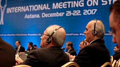 Syrian chief negotiator Bashar Al Ja'afari, right, and other delegates take part in Syria peace talks in Astana on December 22, 2017. Stanislav Filippov / AFP