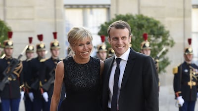 Brigitte Macron, wearing a black dress and Gianvito Rossi heels, accompanies her husband Emmanuel Macron to the Elysee Palace on June 2, 2015. AFP