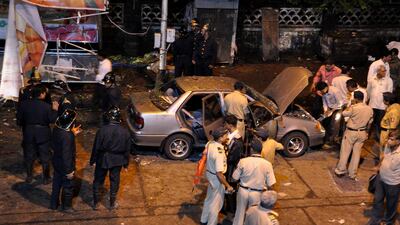 (FILES) This July 13, 2011 file photo shows Indian security personnel and investigators at a bomb blast site in the Dadar District of Mumbai. Triple blasts in Mumbai last week have cast a shadow over the imminent visit of US Secretary of State Hillary Clinton to New Delhi and a new round of India-Pakistan peace talks later this month. AFP PHOTO/Sujit JAISWAL *** Local Caption *** 433144-01-08.jpg
