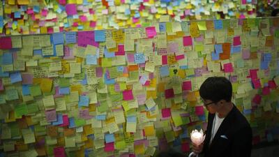 A mourner looks at messages written for victims of the sunken passenger ship Sewol, at a temporary group memorial altar for the victims in Ansan. Kim Hong-Ji / Reuters