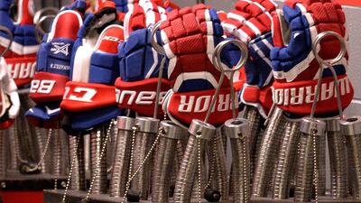 Detail photo of Warrior hockey gloves worn by the Montreal Canadiens during the game against the Carolina Hurricanes at PNC Arena. Grant Halverson / Getty Images / AFP