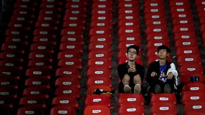 Japanese fans look on from the stands. AFP