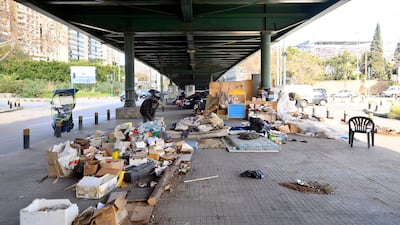 Mohammed Maghrabi inspects books under Fiat bridge in Beirut.