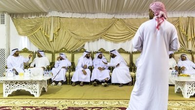 Men gather to pay their respects to the family of Captain Ahmed Khalifa Al Baloushi, 27, a UAE soldier who died in a helicopter crash while serving in Yemen, at a majlis outside the Al Towayya mosque in the Al Towayya area of Al Ain on August 13, 2017. Christopher Pike / The National