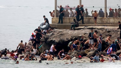 Migrants reach Spanish territory after swimming from Morocco to Ceuta, a Spanish enclave in North Africa. EPA