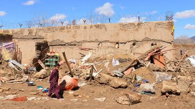 A boy walks inside what is left of a home that was damaged by heavy rains in Kandahar province, south of Kabul, Afghanistan, on March, 3, 2019. AP Photo