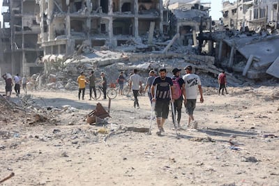 A Palestinian man on crutches in the streets of Shujaiya after the Israeli military withdrew. AFP