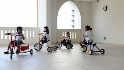 Grade 1 pupils enjoy riding tricycles at school.