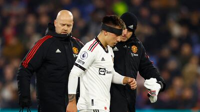 United's Lisandro Martinez wears a head band after receiving medical attention. Action Images