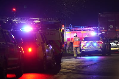 Emergency workers at Babbs Mill Park in Solihull where the children were pulled from the lake. PA .