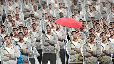 Employees at fitness studio chain McFIT pose with 200 life-size cardboard cutouts of the boxer Wladimir Klitschko at Alexanderplatz in Berlin, Germany. Britaa Pedersen / EPA