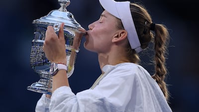Elena Rybakina of Kazakhstan celebrates by kissing the trophy after defeating Aryna Sabalenka. AFP
