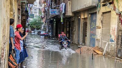 An motorcyclist rides through floodwater after a heavy rainfall in the coastal city of Alexandria in Egypt on October 25, 2015. Heba Khamis/ AP Photo