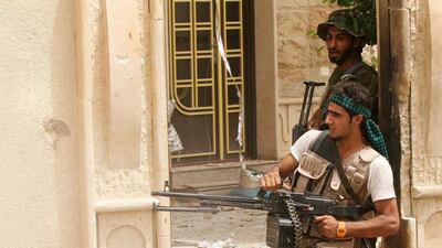 Shiite militia fighters supported by Iraqi security forces search homes looking for ISIL militants after regaining control of the town of Beiji on July 2, 2015. ISIL retaliated on Jul 6 with a number of suicide bomb attacks. AP Photo