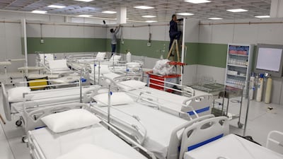 Iranian workers set up a makeshift hospital inside the Iran Mall, northwest of Tehran. AFP