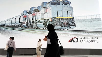 Delegates look at the Etihad Rail poster during the 26th World Road Congress exhibition held at Abu Dhabi National Exhibition Centre in Abu Dhabi. Pawan Singh / The National