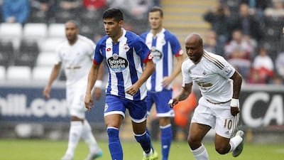 Juanfran of Deportivo La Coruna, left, in action with Andre Ayew of Swansea City. Ian Smith / Reuters