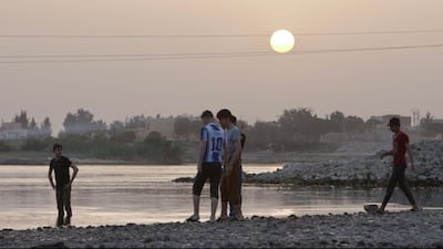 A young residence from Raqqa, swim after a hot day in the Euphrates river. It's the only breathing place of the destroyed Raqqa.. Photo by Daham Alasaad
