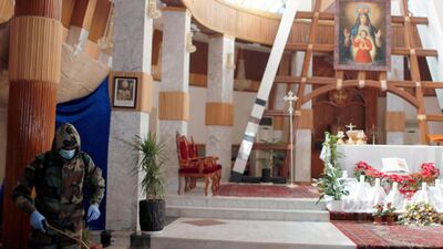A member of the civil defence team disinfects the Our Lady of Salvation Church in Baghdad to prevent the spread of coronavirus. Reuters
