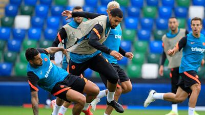 Ruben Loftus-Cheek is tackled during a training session at Windsor Park in Belfast.