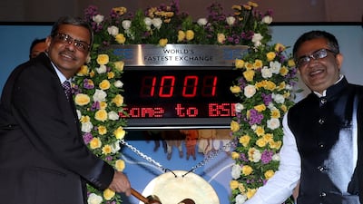 Life Insurance Corporation of India chairman M R Kumar and chief executive of the Bombay Stock Exchange, Ashishkumar Chauhan, hit the ceremonial gong during the company's listing ceremony in Mumbai, on Tuesday. Reuters