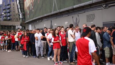 Fans queue to enter the stadium after the match was delayed by 30 minutes because of a turnstiles issue. Getty